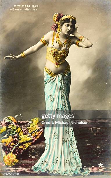 Hand colored postcard of Mata Hari performing the "Danse Indienne" taken by Paul Boyer in 1907. Mata Hari was later executed in France for spying for...