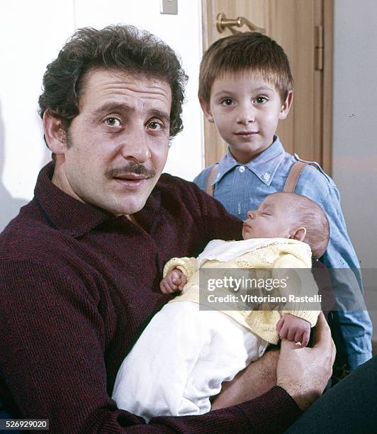 Italian singer, songwriter and actor Domenico Modugno at his home in Rome, with his sons Marcello and Marco, born a few days ago.