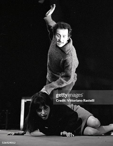 Italian singer, songwriter and actor Domenico Modugno with actress Adriana Asti on the set of a television show.