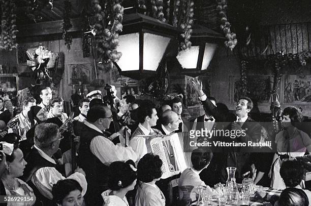 Italian singer, songwriter and actor Domenico Modugno performing in the restaurant Meo Patacca, in Rome.