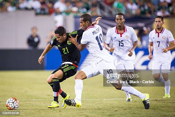 Mexico National Soccer team player Carlos Esquivel gets physical for control with Costa Rico player Roy Miller during the Soccer, 2015 CONCAAF Gold...