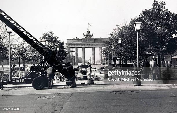 The Berlin Wall, under construction in August 1961. Taken from Unter den Linden on the East side, the photograph shows the Brandenburg Gate warning...