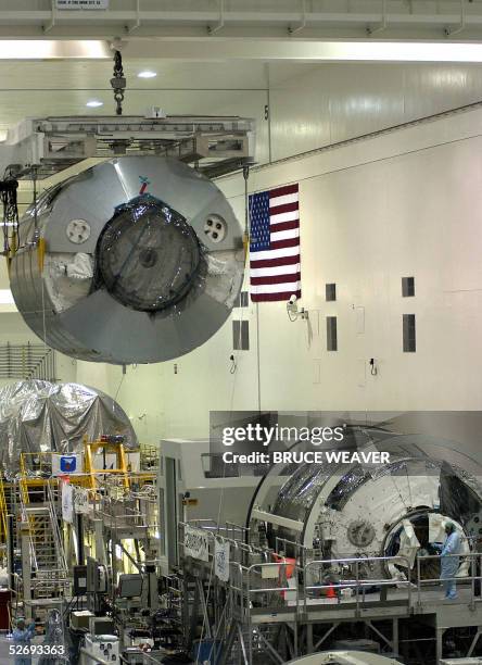 The Italian built Multi-Purpose Logistics Module Raffaello is moved 25 April 2005, past the other Italian built module Leonardo in the Space Station...