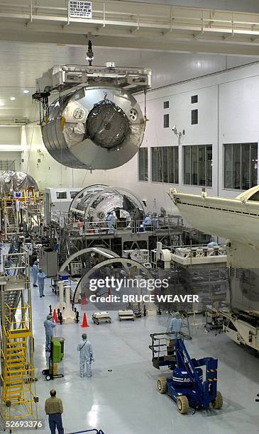 The Italian built Multi-Purpose Logistics Module Raffaello is moved 25 April 2005, past the other Italian built module Leonardo in the Space Station...