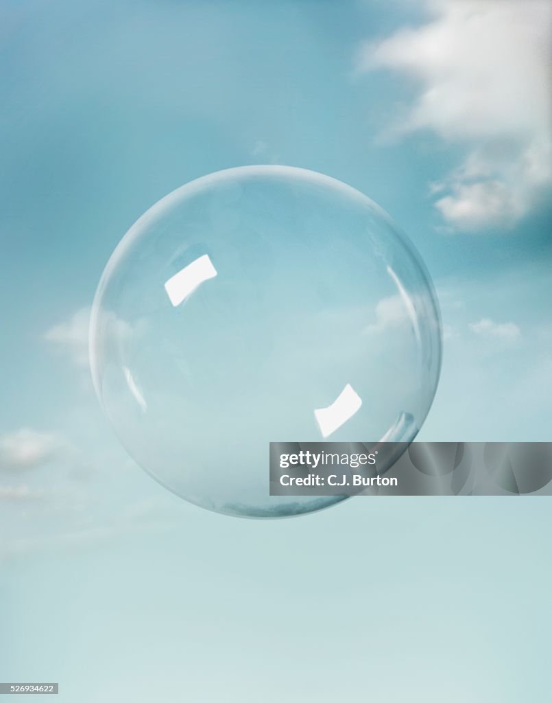 Transparent sphere floating in sky