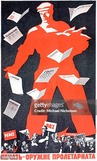 Russian Communist poster showing a giant worker distributing the Communist newspapers of many countires, including Pravda, France's L'Humanite,...