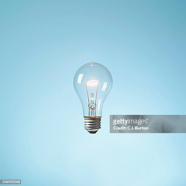 illuminated lightbulb - light bulb stock pictures, royalty-free photos & images