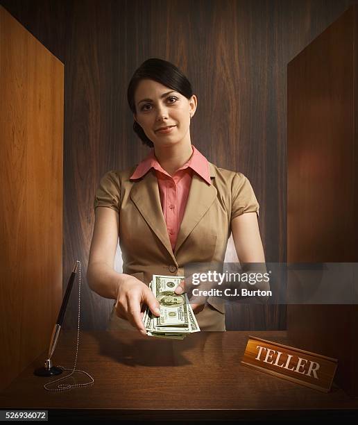 bank teller giving us currency - money borrow stockfoto's en -beelden