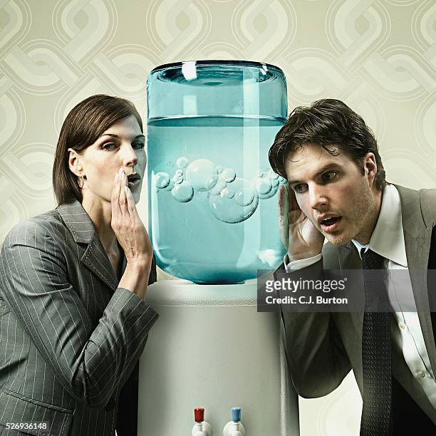 businesswoman whispering into a water cooler - office politics stock pictures, royalty-free photos & images