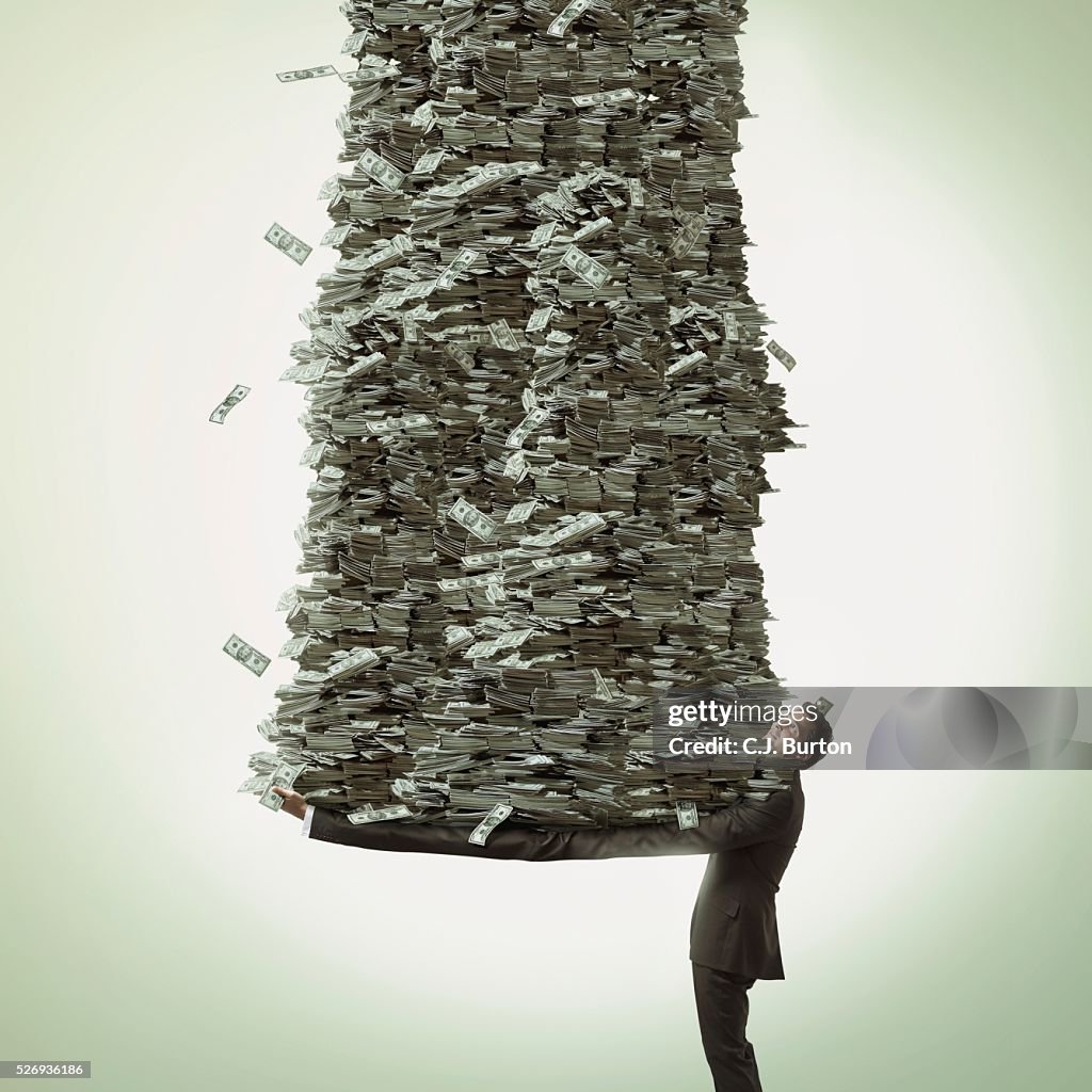 Businessman with long arms holds a stack of cash