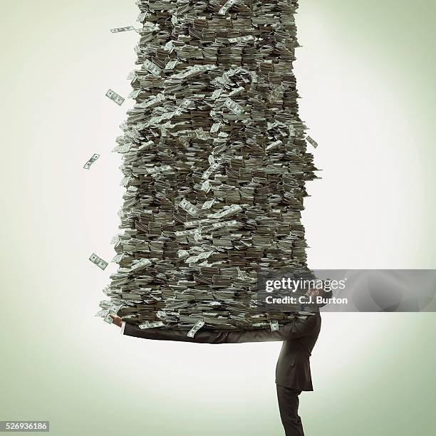 businessman with long arms holds a stack of cash - millionnaire ストックフォトと画像