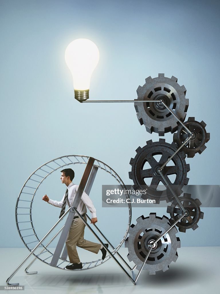 Businessman running on exercise wheel