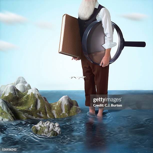 charles darwin standing by the galapagos islands - darwin 個照片及圖片檔