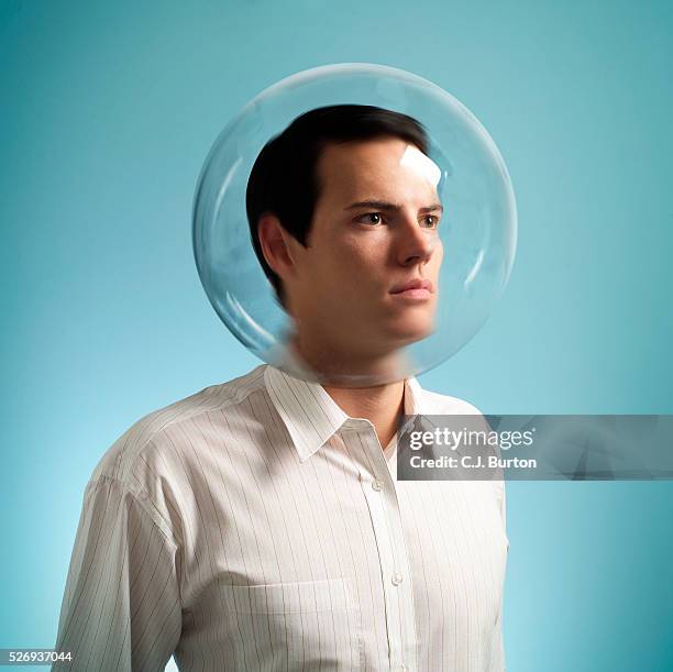 studio shot of man wearing bubble - indifferenza foto e immagini stock