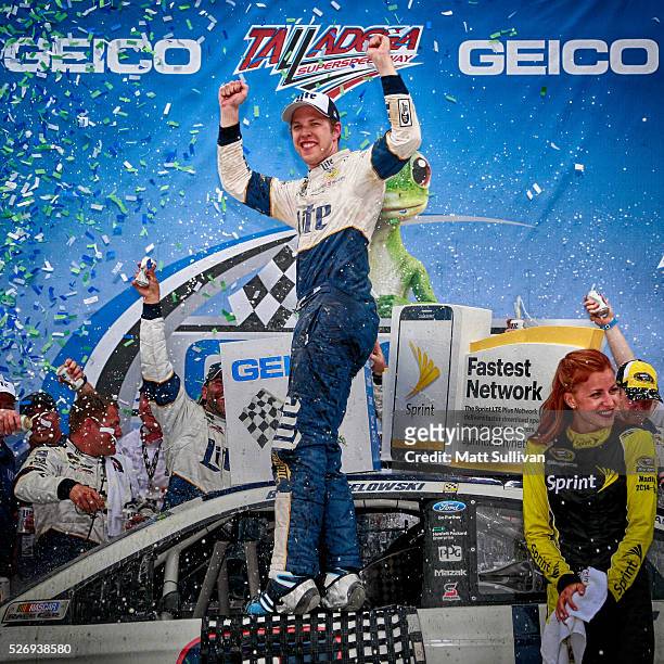 Brad Keselowski, driver of the Miller Lite Ford, celebrates in Victory Lane after winning the NASCAR Sprint Cup Series GEICO 500 at Talladega...