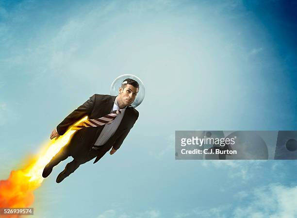 rocket businessman flying in sky - accelerate business stock-fotos und bilder