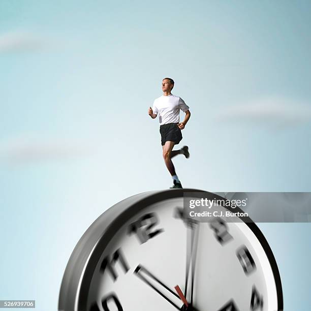 man running on rolling clock - duration of training stock pictures, royalty-free photos & images