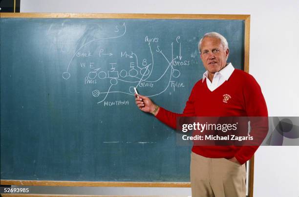 Head coach Bill Walsh of the San Francisco 49ers diagrams a play on a chalkboard before their game against the New England Patriots at Foxboro...