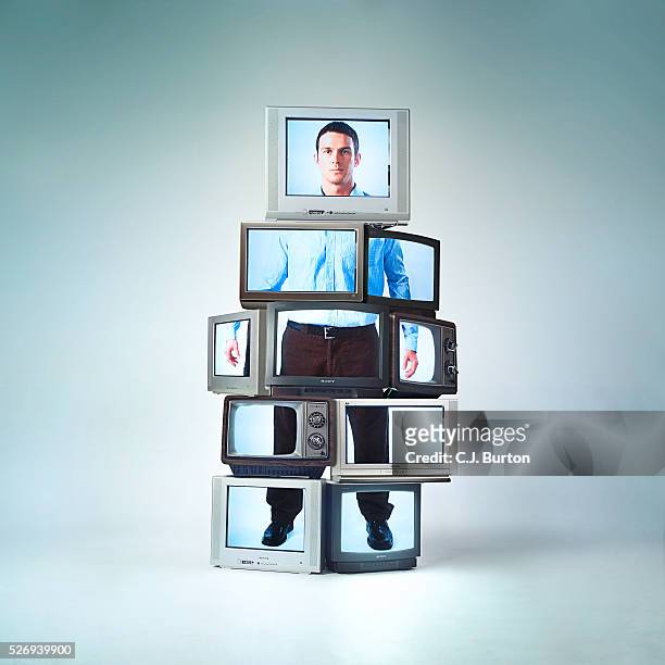 stack of tv sets making showing image of young man - conspiracy stock pictures, royalty-free photos & images