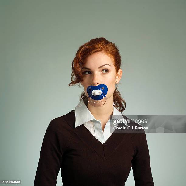 young woman with pacifier in mouth - adulto foto e immagini stock