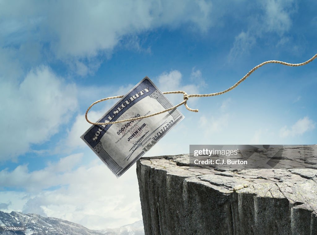Social security card is teetering on side of cliff