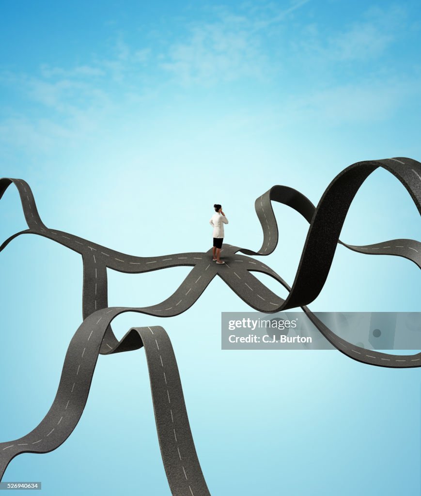 Woman in white coat stands in middle of several crossroads floating in sky