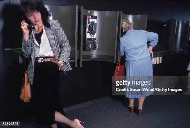 Belgian-born fashion designer Diane von Furstenberg talks on a pay phone at John F. Kennedy Airport in Queens, New York, May 1979. Furstenberg is...