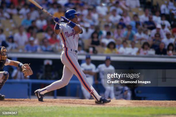 Outfielder Darryl Strawberry of the New York Mets follows through after hitting a pitch during a game in 1987 against the Los Angeles Dodgers at...
