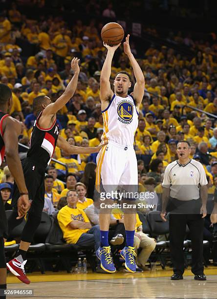 Klay Thompson of the Golden State Warriors shoots a three-point basket against the Portland Trail Blazers during Game One of the Western Conference...