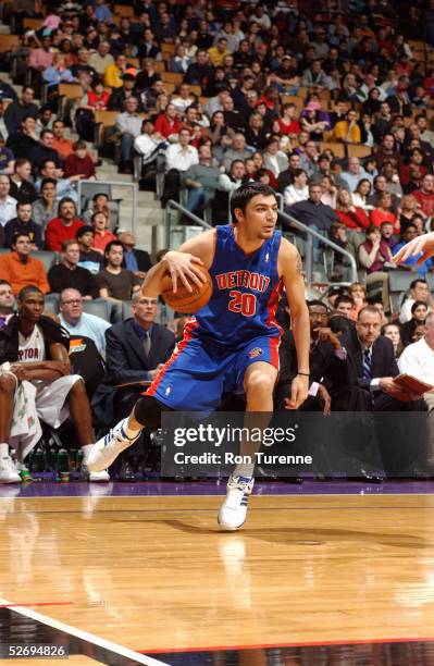 Carlos Delfino of the Detroit Pistons moves the ball against the Toronto Raptors during the game on April 3, 2005 at the Air Canada Centre in...
