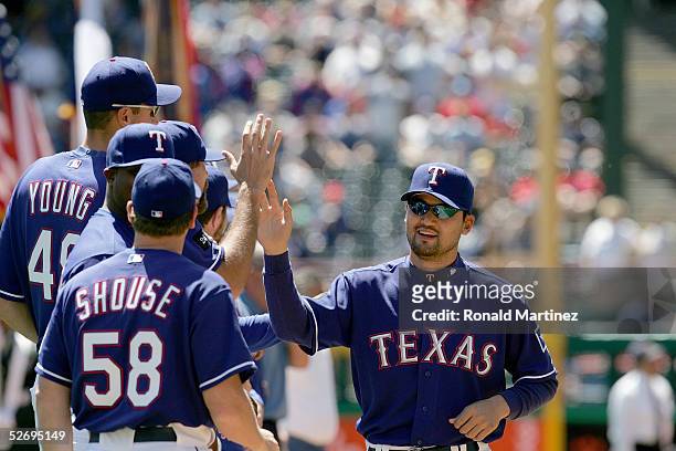 Adrian Gonzalez of the Texas Rangers celebrates with teammates after play against the Los Angeles Angels of Anaheim on April 11, 2005 at Ameriquest...