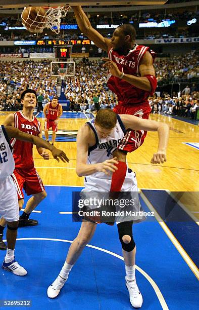 Forward Tracy McGrady of the Houston Rockets makes the slam dunk on top of Shawn Bradley of the Dallas Mavericks in Game two of the Western...