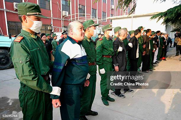 Chinese police escort convicted criminal gang members for execution on April 25, 2005 in Xuchang of Henan Province, central China. Gang leader Song...