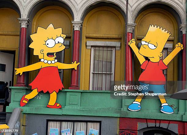Lisa Simpson and Bart Simpson cut-outs on display at "The Simpsons" 350th episode block party on the New York street of Fox Pico Lot on April 25,...