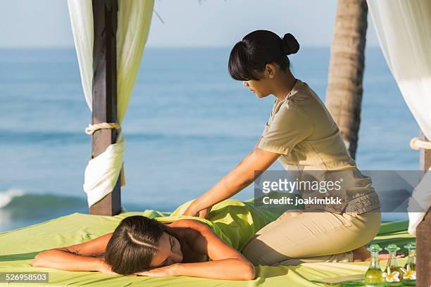 young woman having an asian massage - bali spa stock pictures, royalty-free photos & images