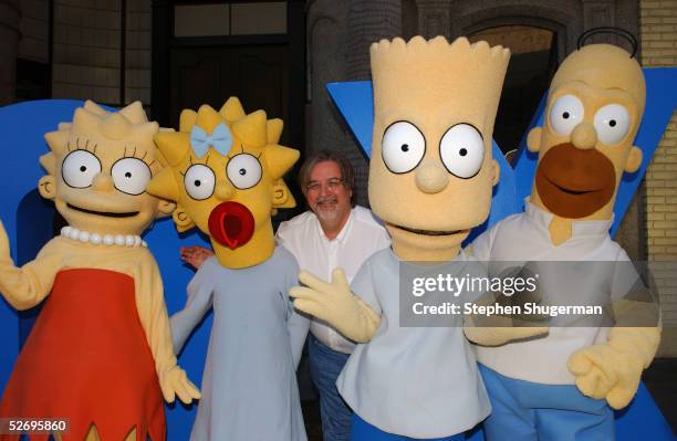The Simpsons" creator/executive producer Matt Groening poses with characters Lisa, Maggie, Bart and Homer at "The Simpsons" 350th episode block party...