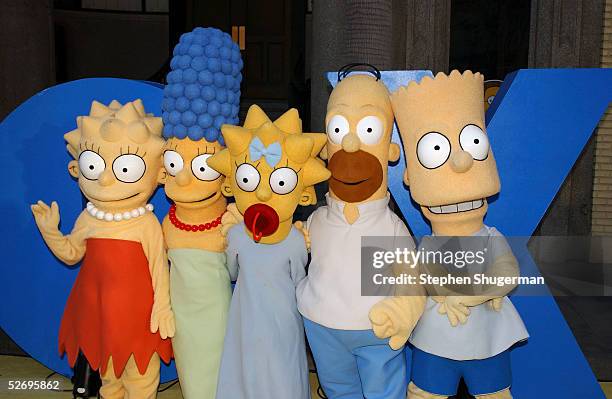The Simpsons characters Lisa, Marge, Maggie, Homer and Bart Simpson pose for a photograph at "The Simpsons" 350th episode block party on the New York...