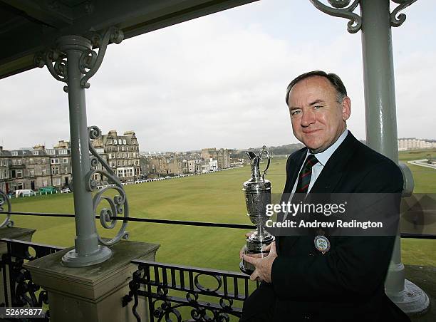 Peter Dawson, the Secretary of the Royal and Ancient Golf Club, poses with the Open Championship trophy on the balcony of the clubhouse on April 26,...