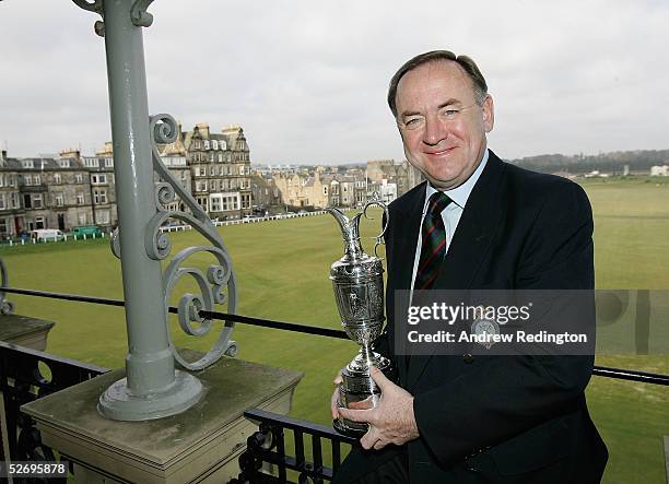 Peter Dawson, the Secretary of the Royal and Ancient Golf Club, poses with the Open Championship trophy on the balcony of the clubhouse on April 26,...