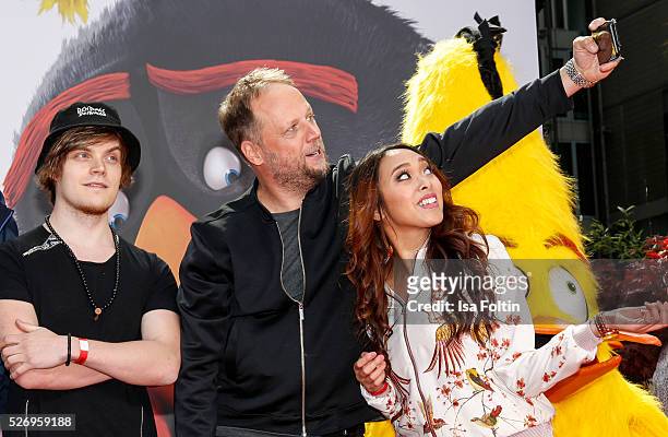 IBlali, Smudo and Christina Ann Zalamea aka Hello Chrissy make a selfie during the Berlin premiere of the film 'Angry Birds - Der Film' at CineStar...