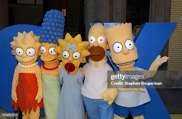 The Simpsons characters Lisa, Marge, Maggie, Homer and Bart Simpson attend "The Simpsons" 350th episode block party on the New York street of Fox...