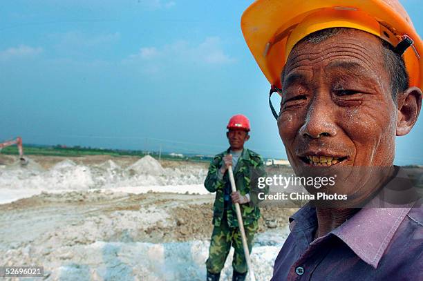 Migrants work at a highway construction site on April 25, 2005 in Feidong County of Anhui Province, East China. There has been a lot of concern for...