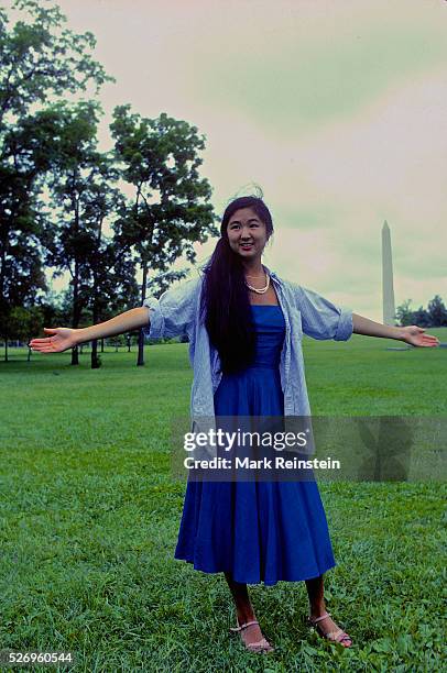 Washington, DC. 9-1981 Maya Lin stands at site of where she wants the Vietnam Veterans memorial to be placed. She is holding her arms out at the...