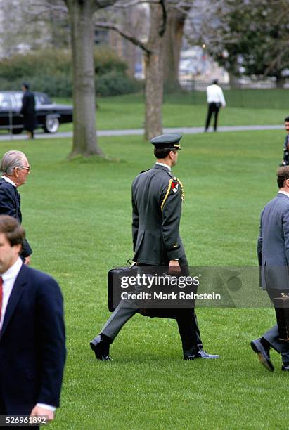 Washington, DC. 1986 Military Aid carrying the "Black Bag" with the nuclear war codes . Credit: Mark Reinstein