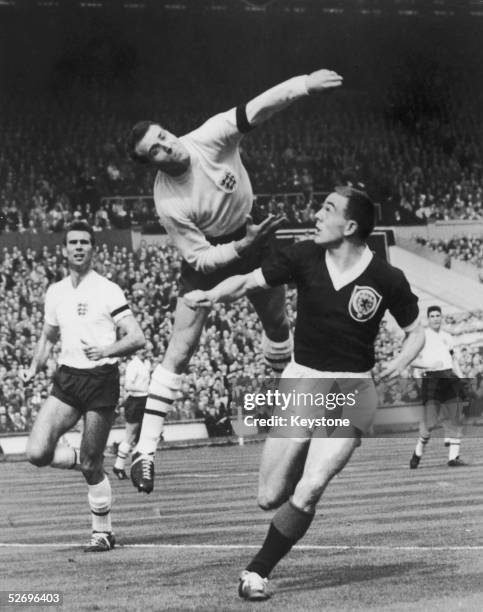 England goalkeeper Ron Springett punches the ball clear in the opening minutes of a Soccer International match against Scotland at Wembley Stadium,...