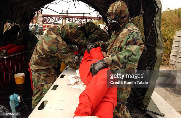 During the simulation, United States Marines wash probationary firefighters playing the role of bio-chemical victims. At the Fire Department of New...