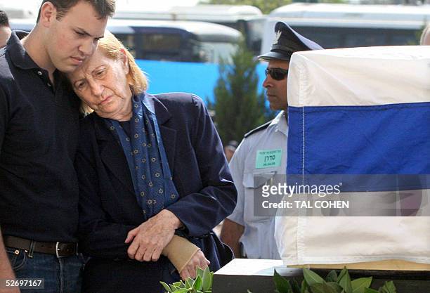 Reuma Weizman mourns the death of her husband Eizer Weizman 26 April 2005 next to his coffin at the Israeli town of Or Akiva. Israel paid its final...