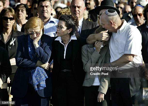 Reuma Weizman , the widow of former Israeli President Ezer Weizman, and his daughter Michal stand with unidentified grieving mourners at the burial...