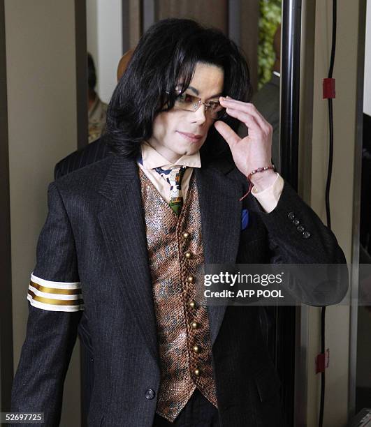 Pop star Michael Jackson removes his glasses as he passes through a magnetometer at the Santa Barbara County courthouse 26 April 2005 in Santa Maria,...