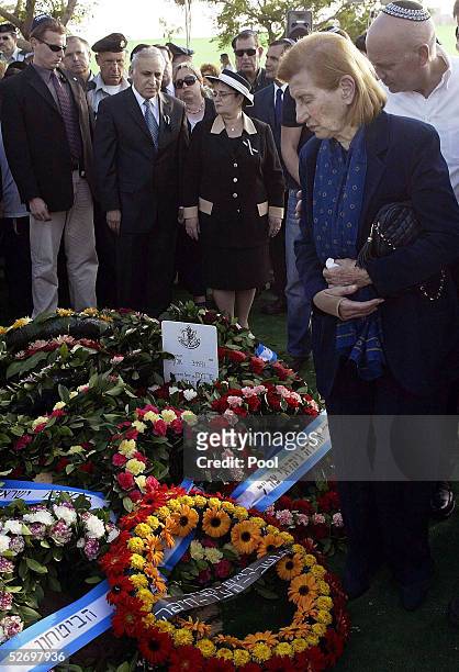 Reuma Weizman , widow of former Israeli President Ezer Weizman, stands over her husband's flower-covered grave during his state funeral April 26,...